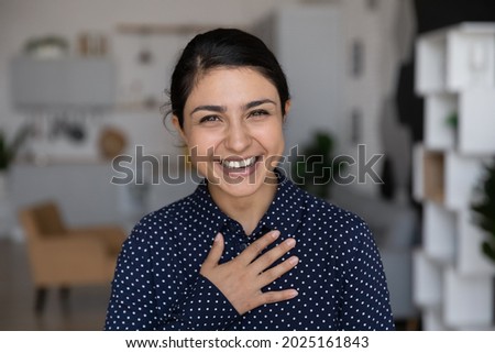 Headshot portrait of smiling young Indian woman look at camera feeling optimistic. Profile picture of happy millennial biracial female client or customer posing. Diversity, employment concept.