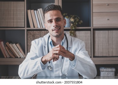 Headshot Portrait Of Smiling Young Male GP Or Physician In White Medical Uniform And Glasses Look At Camera Posing In Hospital, Happy Caucasian Man Doctor Show Confidence Skills In Clinic Workplace