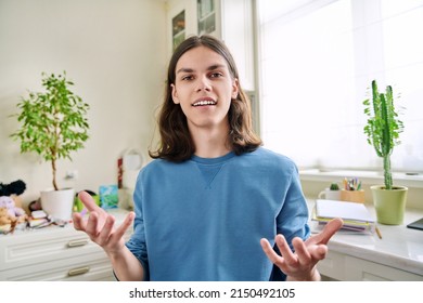 Headshot Portrait, Teenage Male Student Talking Looking At Camera.