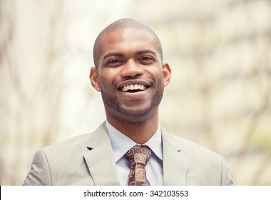 Headshot Portrait Of Young Professional Man Smiling Laughing Isolated On Outside Outdoors Corporate Office Background. Positive Human Emotions Feelings Facial Expressions 