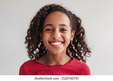 Headshot Of Positive African American Preteen Girl Smiling Posing Looking At Camera On Gray Background In Studio, Wearing Casual Clothes. Child's Portrait. Kids Beauty And Style Concept. Front View - Shutterstock ID 2120760737