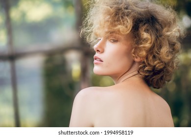 Headshot Of A Serious Young Woman With Naked Shoulders