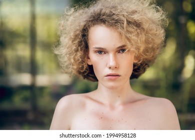 Headshot Of A Serious Young Woman With Naked Shoulders