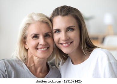 Headshot Of Smiling Young Woman And Old Mother Looking At Camera Posing For Family Portrait, Happy Beautiful Grown Daughter And Aged Mom Bonding Together, Younger And Older Age Generations Concept