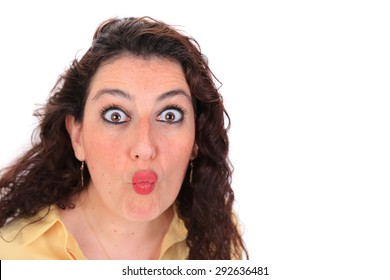 Headshot Of A Spanish Woman With Dark Hair Brown Eyes Wearing A Yellow Blouse Throwing A Kiss