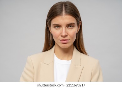 Headshot Of Strict Woman Teacher Looking At Camera With Serious Facial Expression. Unsatisfied Female CEO Having Work Troubles Isolated On Gray Background