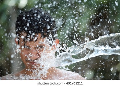 Headshot Of Teen Boy Getting Splashed Of Water