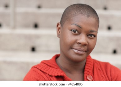 Headshot Of A Young Black Woman With A Shaved Head