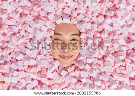 Similar – Image, Stock Photo Young adult woman lying in bed and with her cat and pile of books in her hands