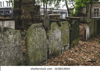 Headstones in Bunhill Fields, which is a former burial ground in central London. A headstone, tombstone, or gravestone is a stele or marker, usually stone, that is placed over a grave - Powered by Shutterstock