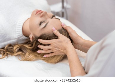 Healer performing by lightly touched access bars therapy on young woman head, stimulating positive change thoughts and emotions. Alternative medicine concept. High quality photo - Powered by Shutterstock