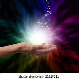 Healer's Hand Outstretched Into Magical Healing Energy Field With Sparkles And Rainbow Colors On A Black Background