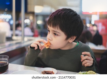 Healhty Young Boy Eating Salmon Sashimi In Japanese Buffet Restaurant , Kid Using Chopsticks Having Japanese Food For Lunch In The Cafe