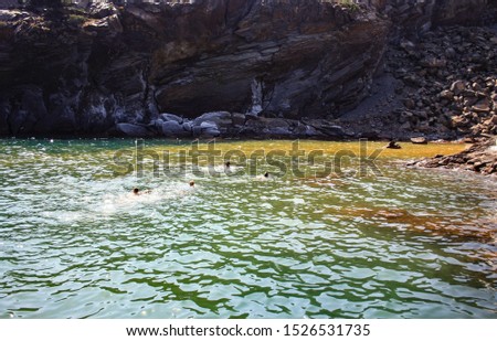 Healing baths in the hot springs of Palea Kameni off the coast of Santorini