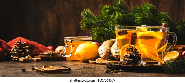 Healing Black Winter Tea With Ginger, Honey, Lemon. Immune Booster Drink In Glass Cup On Rustic Wooden Table Background With Copy Space