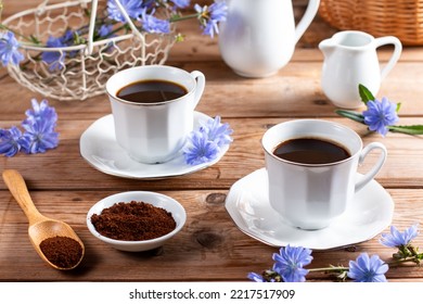 Healing drinks. Chicory drink. Cup of chicory drink and flowers on a wooden table - Shutterstock ID 2217517909