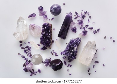 Healing purple amethyst stones on white background. Crystals for ritual