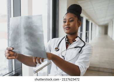 Healt And Medicine Concept - Smiling Female Doctor Studying X-ray