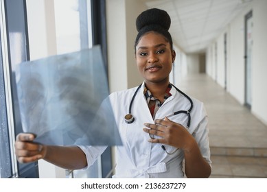 Healt And Medicine Concept - Smiling Female Doctor Studying X-ray