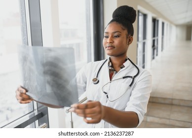 Healt And Medicine Concept - Smiling Female Doctor Studying X-ray