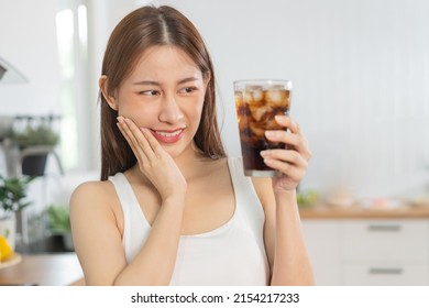 Health asian young woman touching cheek, expression, suffering from toothache, decay or sensitivity cavity molar tooth, teeth or inflammation drink cold, sparkling water at home.Sensitive teeth people