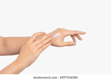 Health and beauty care of young Asian woman using her fingers to apply moisturizing cream to the back of her hands, body cream - Powered by Shutterstock