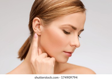 Health And Beauty Concept - Face Of Beautiful Woman Touching Her Ear