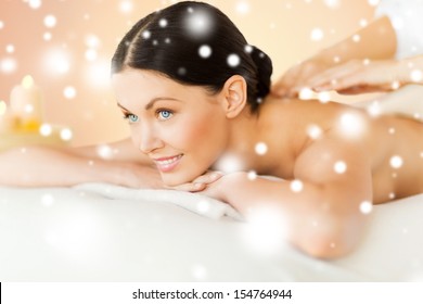 health and beauty concept - woman in spa salon getting massage