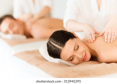 health and beauty, resort and relaxation concept - couple in spa salon getting massage