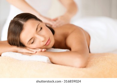 Health, Beauty, Resort And Relaxation Concept - Beautiful Woman With Closed Eyes In Spa Salon Getting Massage