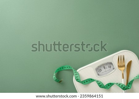 Health and body transformation theme. Top view photo showcasing floor scales, tape measure, fork, and knife on green setting, ideal for text or advertising