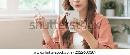 Health care asian young woman using smart mobile for reading, searching prescription medicine, pills label text about medical information online, instructions side effects, pharmacy medicament concept
