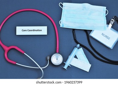 Health Care Concept Demonstration Coordination With Nurse Name Tag On Lanyard, Mask, Syringe, And Stethoscope Placed On Navy Blue Background