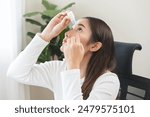Health care concept, eye problem asian young woman applying, using medical eye drops to treat dry eye and irritation, suffering from irritated eye dry eyes or inflammation, allergy optical symptom.