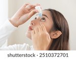 Health care concept, eye problem asian young woman applying, using medical eye drops to treat dry eye and irritation, suffering from irritated eye dry eyes or inflammation, allergy optical symptom.