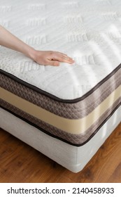Health care concept. Woman inspecting new bed topper on sleeping mattress. Female hand pressing on polyurethane material, checking best quality of product for healthy sleeping at home