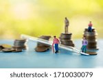 Health care conceptual miniture and thermomiter with coins stack background