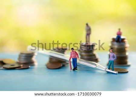 Health care conceptual miniture and thermomiter with coins stack background