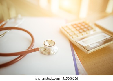 Health Care Costs Concept Picture : Selective Focus Stethoscope And Calculator On A Medical Chart ,symbol For Health Care Costs Or Medical Insurance With Effect Light Added.