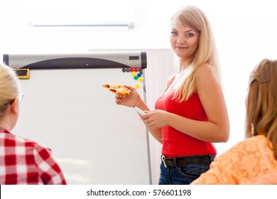 Health Care, Dieting, Healthy Nutrition Concept. Dietician Woman Holding Bad Bun Junk Food, Giving Lesson, Group Of Young Women Listening