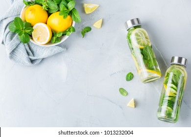 Health care, fitness, healthy nutrition diet concept. Fresh cool lemon cucumber mint infused water, cocktail, detox drink, lemonade in a glass jar. Light copy space top view flat lay background