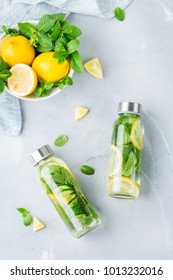 Health care, fitness, healthy nutrition diet concept. Fresh cool lemon cucumber mint infused water, cocktail, detox drink, lemonade in a glass jar. Light top view flat lay background 库存照片