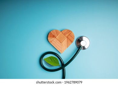 Health Care, Harmony and Organic Healthy Lifestyle Concept. Living and Close to Nature. Wooden Jigsaw as Heart Shape with Stethoscope and Leaf. Look like Flower Plant. Growth of Love and Relationship - Shutterstock ID 1962789079