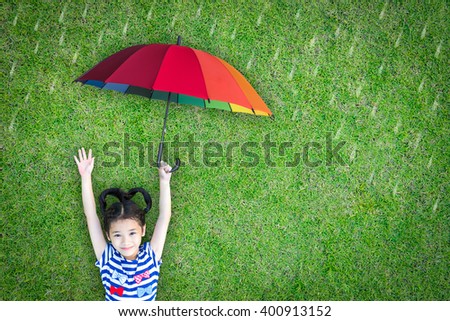 Health care insurance concept for family and children medical healthcare protection, flu prevention immunization with happy asian school girl kid holding umbrella under the rain on green lawn
