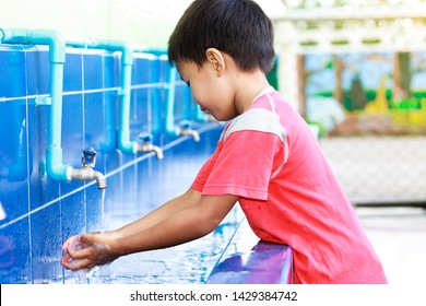 Health Care And Kid Concept. Asian Child Boy Washing His Hands Before Eating Food And After Play The Toys At The Washing Bowl. A Boy Aged Of 5 Years Old.