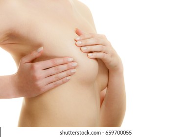 Health care medical concept. Young woman examining her breasts for lumps or signs of breast cancer isolated on white