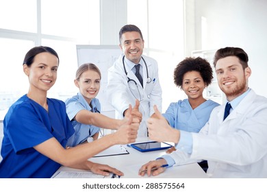 Health Care, Medical Education, People And Medicine Concept - Group Of Happy Doctors Or Interns With Mentor Meeting And Showing Thumbs Up Gesture At Hospital