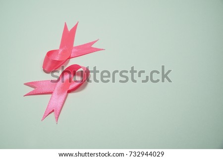 Health care and Medicine Concept - A pink ribbon over a white background. Breast cancer awareness pink sign symbol for help illness people