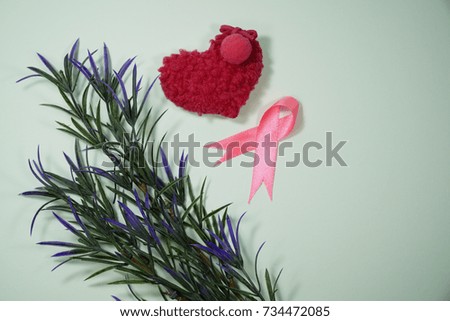 Health care and Medicine Concept - A pink ribbon, a pink heart shape and a leaf over a white background. Breast cancer awareness pink sign symbol for help illness people