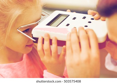 health care, medicine, people, eyesight and technology concept - close up of optometrist with pupillometer checking patient intraocular pressure at eye clinic or optics store - Powered by Shutterstock